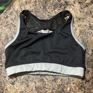 black sports bra with silver band with mesh on tue back